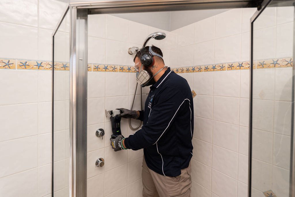 Removing old grout from shower wall tiles